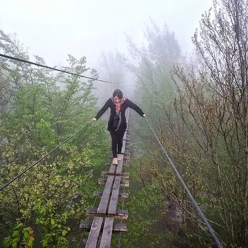 A woman walks on the suspension bridge of Ramsar, Mazanda