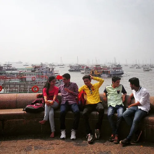 Friends hang out at the India Gate pier in Mumbai India. 