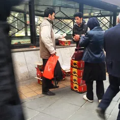 A man sells Dates on the sidewalk in Tehran