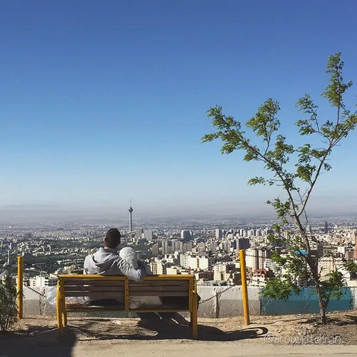 A young couple are enjoying the view of the city from Baa