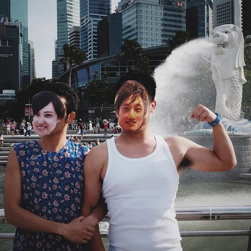 Tourists from South Korea posing in front of Merlion Park