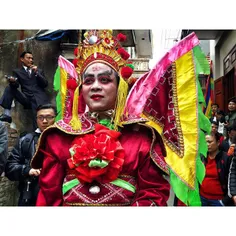 A man is seen in traditional costumes and prepared for ri