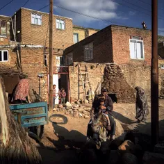 A man with his little boy on his donkey returning from hi