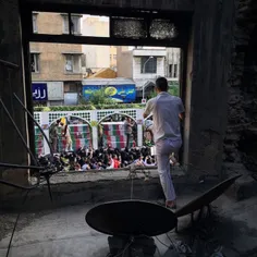 A man takes a photo from the public funeral ceremony of 1