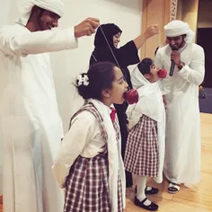 Female pupils bob for apples in #Sharjah, #UAE. Photo by 