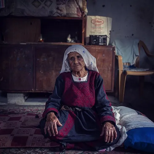 89-year-old Halima Al Moghrabi sits in her temporary hous