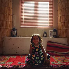 Massara, a 4-year-old Iraqi girl, sits in the Muthief (gu