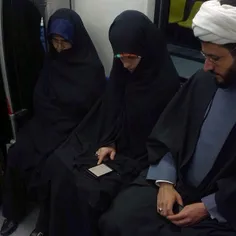 A Muslim clergyman along with his family in a subway trai