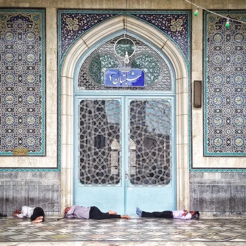 Muslim men take a nap at the Massoumeh shrine in the holy