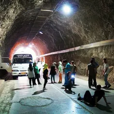 Passengers amuse themselves as their broken bus gets fixe