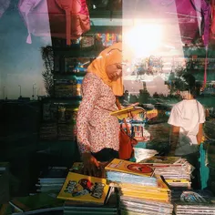 A mother and her son choosing school tools 