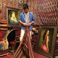 A man folding a rug at his carpet shop. #Tehran Bazaar. #