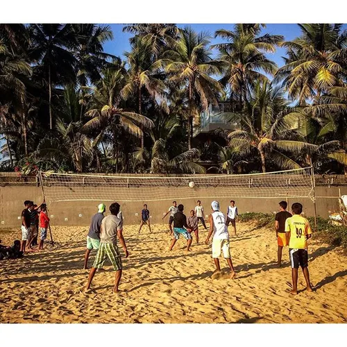 People play volleyball on a beach in Mumbai, India. Photo