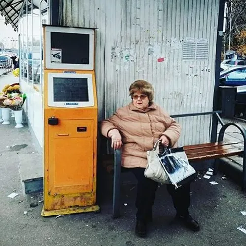 Lady waits at bus stop in Chisinau. Moldova. Photo by Ram