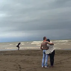 A couple hugs each other by the Caspian sea. #MahmoudAbad