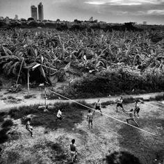 Workers are playing volleyball after working time, on the