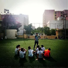 A junior football team’s coach gives his team some tips b