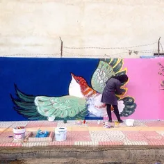 A woman painting a mural in a neighboroud in #Sari, #Maza