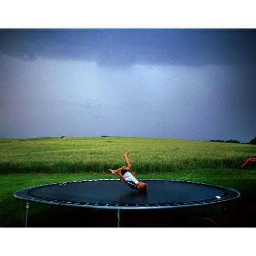 On a trampoline, just before a thunderstorm, on a farm ou