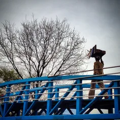 A street vendor crosses the overhead bridge while he walk