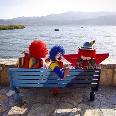 A group of clowns take a rest by the side of Lake Zarivar