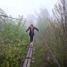 A woman walks on the suspension bridge of #Ramsar, #Mazan