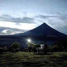 A couple enjoys the view atop Lignon Hill fronting the ma