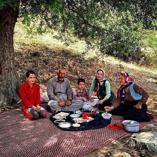 A family has lunch after working hard on their farm. Saqe