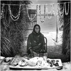 A woman sells her handicrafts at a flea market in Hengam 