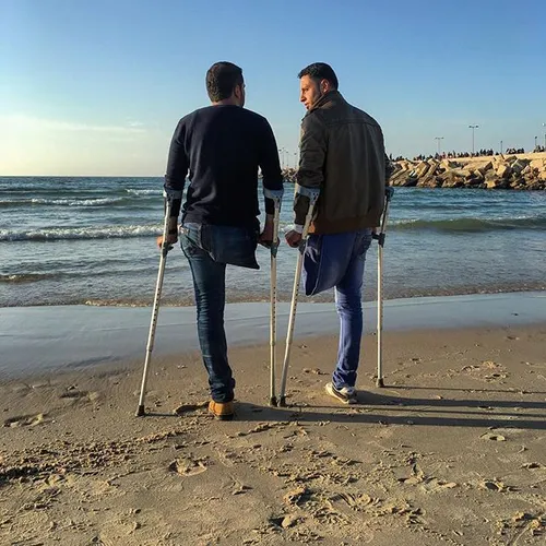 Two Palestinian colleagues who lost their legs in an Isra