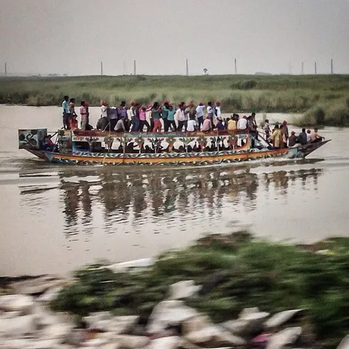 Men dance to music on top of a boat in Dhaka, Bangladesh.