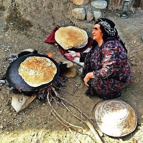 A woman makes bread in a traditional way. NowrouzAbad Vil