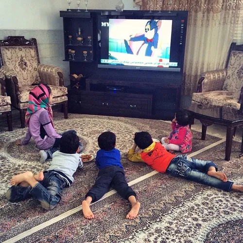 Kids are watching Tom & Jerry on television. Yazd Iran