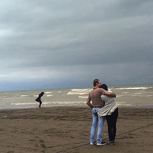A couple hugs each other by the Caspian sea. MahmoudAbad,