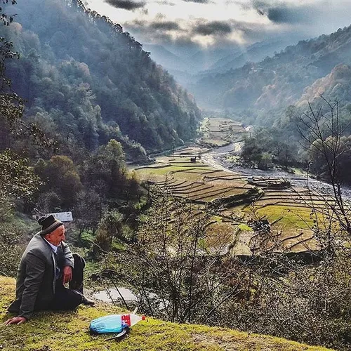 A shepherd takes a break by a side road in Babol heights.