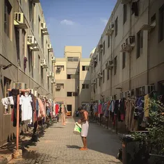 A man finishes hanging his laundry at a labour camp in #D