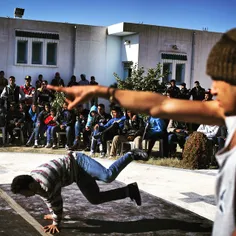 A Tunisian boy performs a break dance move during a youth