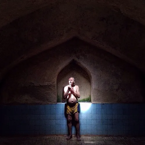 A man washes his body at an old public bath called ‘Garma