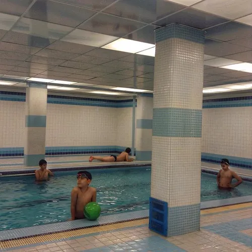 A group of teenage boys enjoying the pool time in a priva