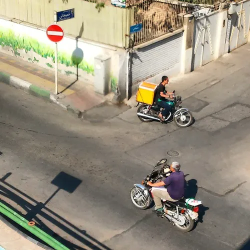 Motorcycle driving on the sidewalk، the opposite directio