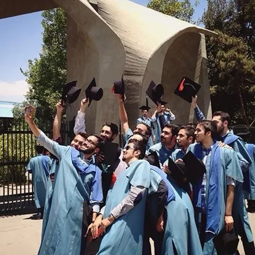 Graduated students take a selfie in front of the main ent
