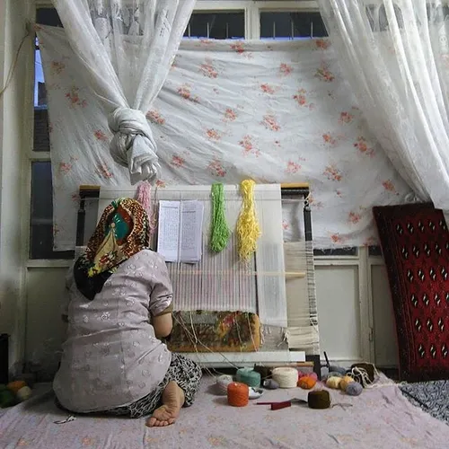 A woman weaving a carpet in a traditional way. Shahriar, 