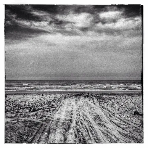 Car tire tracks in the sand, and the great Caspian Sea, i