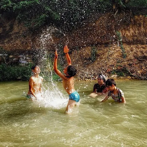 A family has fun in a spring at Farang Village. Galikash,