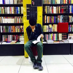 A man reads a book in a book store. #Tehran, #Iran. Photo