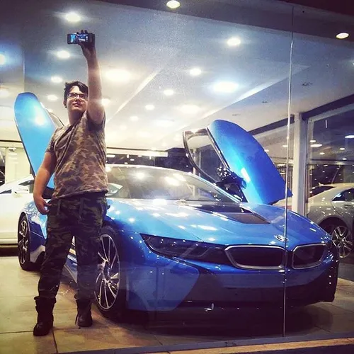 A man takes a selfie with a BMW i8. Tehran, Iran. Photo b