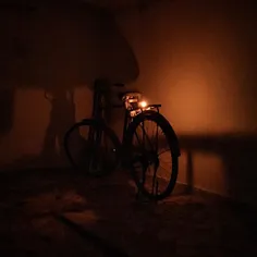 An Indian labour puts a Diya (oil lamp) on his bicycle wh