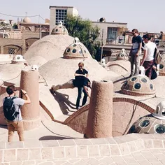 Tourists take photos at the roof of Sultan Amir Ahmad Bat