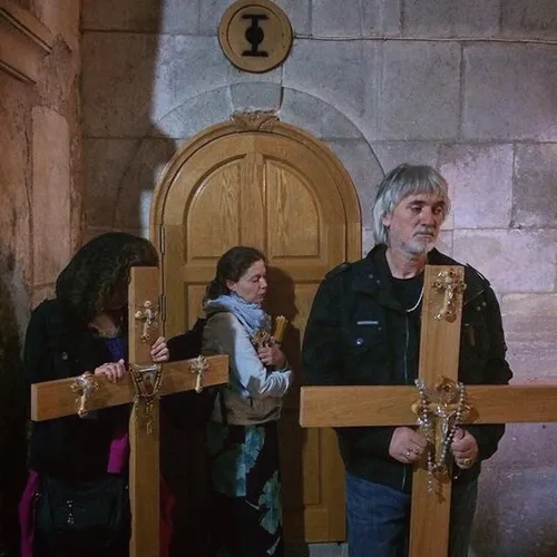 Christian worshippers carry crosses as they enter the Chu