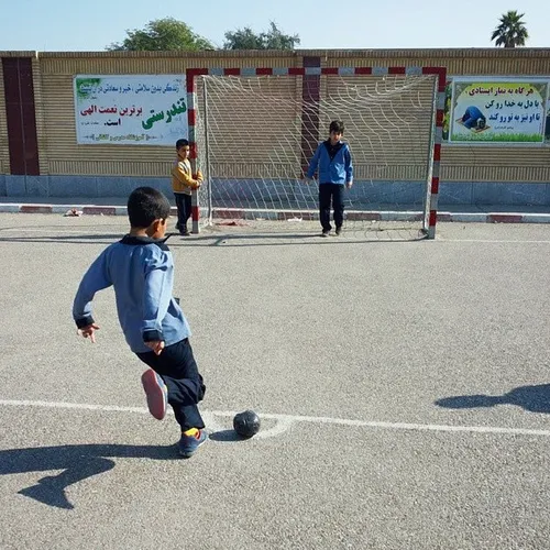 Elementary students playing football at the schoolyard. A